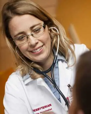 Doctor smiling down at patient